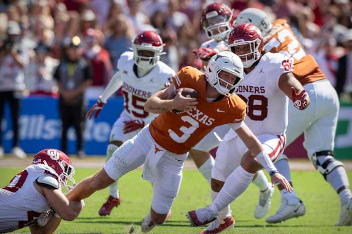 Texas Longhorn QB Quinn Ewers gets tackled on Saturday in Dallas against Oklahoma.